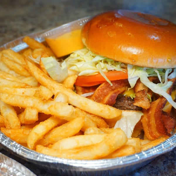 A Pantano's Eatery bacon cheeseburger with lettuce and tomato, served with a side of fries.